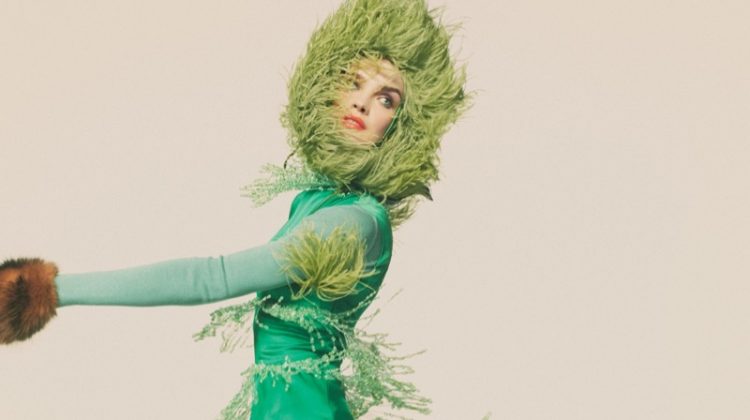 Striking a pose, Natalia Vodianova models Prada dress and hat, Salvatore Ferragamo turtleneck and Louis Vuitton boots