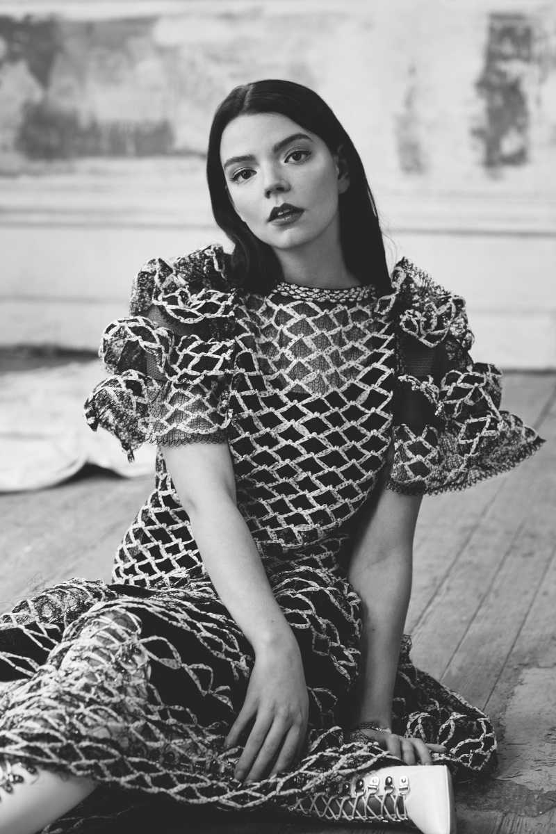 Photographed in black and white, Anya Taylor-Joy wears Chanel dress