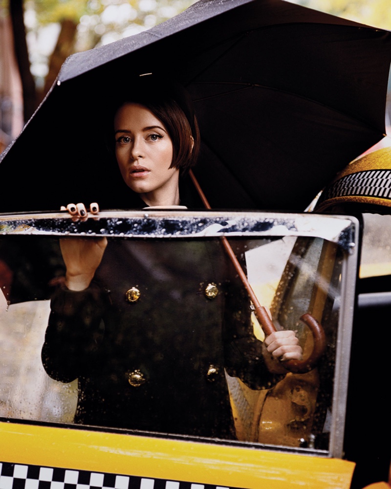 Posing next to a cab, Claire Foy wears Prada coat and headband