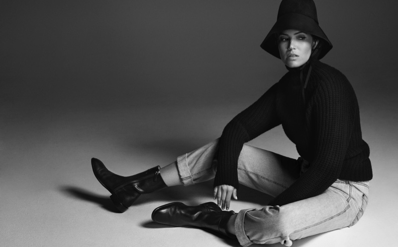 Captured in black and white, Mandy Moore wears Valentino hat, Officine Generale sweater, Brunello Cucinelli pants and Salvatore Ferragamo boots