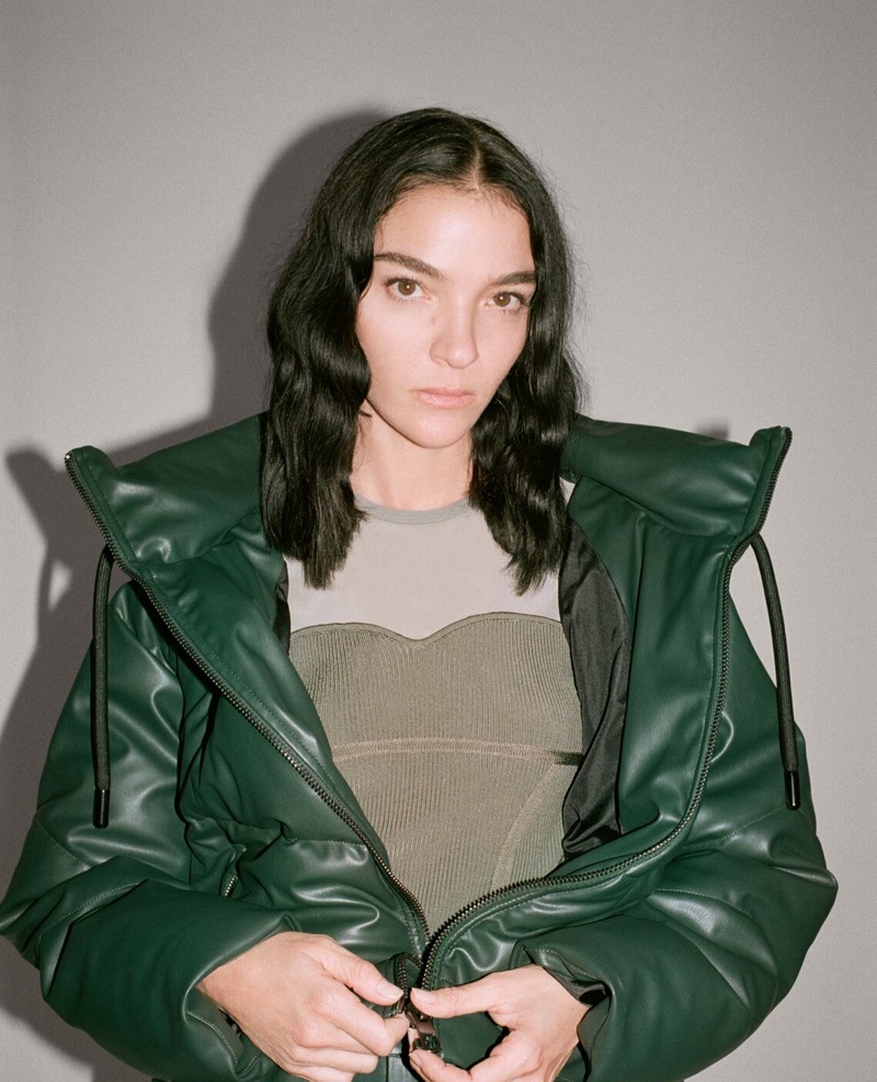 Dressed in green, Mariacarla Boscono wears Zara's faux leather styles.