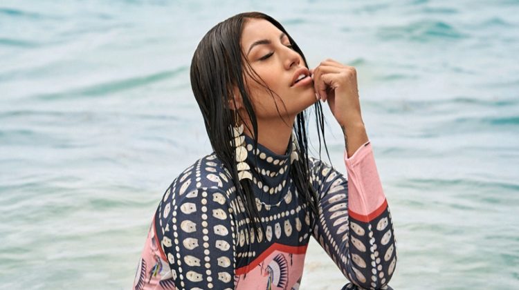 Posing in water, Ashley Callingbull wears Lauren Good Day dress and Indi City earrings. Photo: Gabor Jurina / FASHION