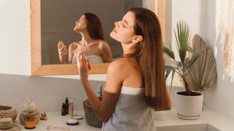 Woman Applying Perfume Bathroom Mirror