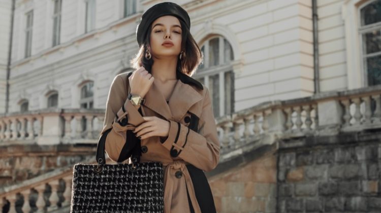 model tan trench coat statement handbag hat