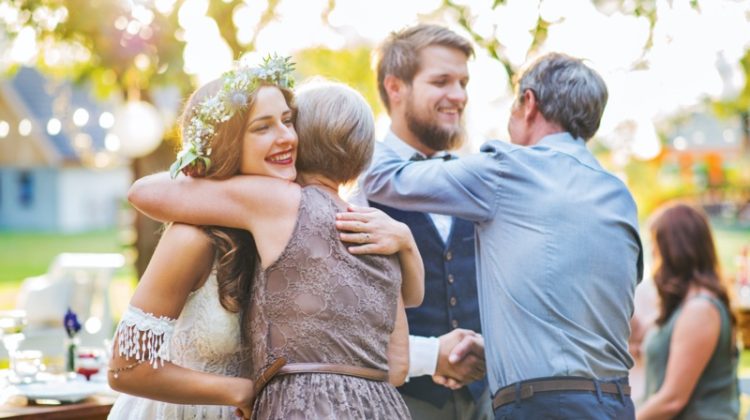 wedding parents hugging married couple